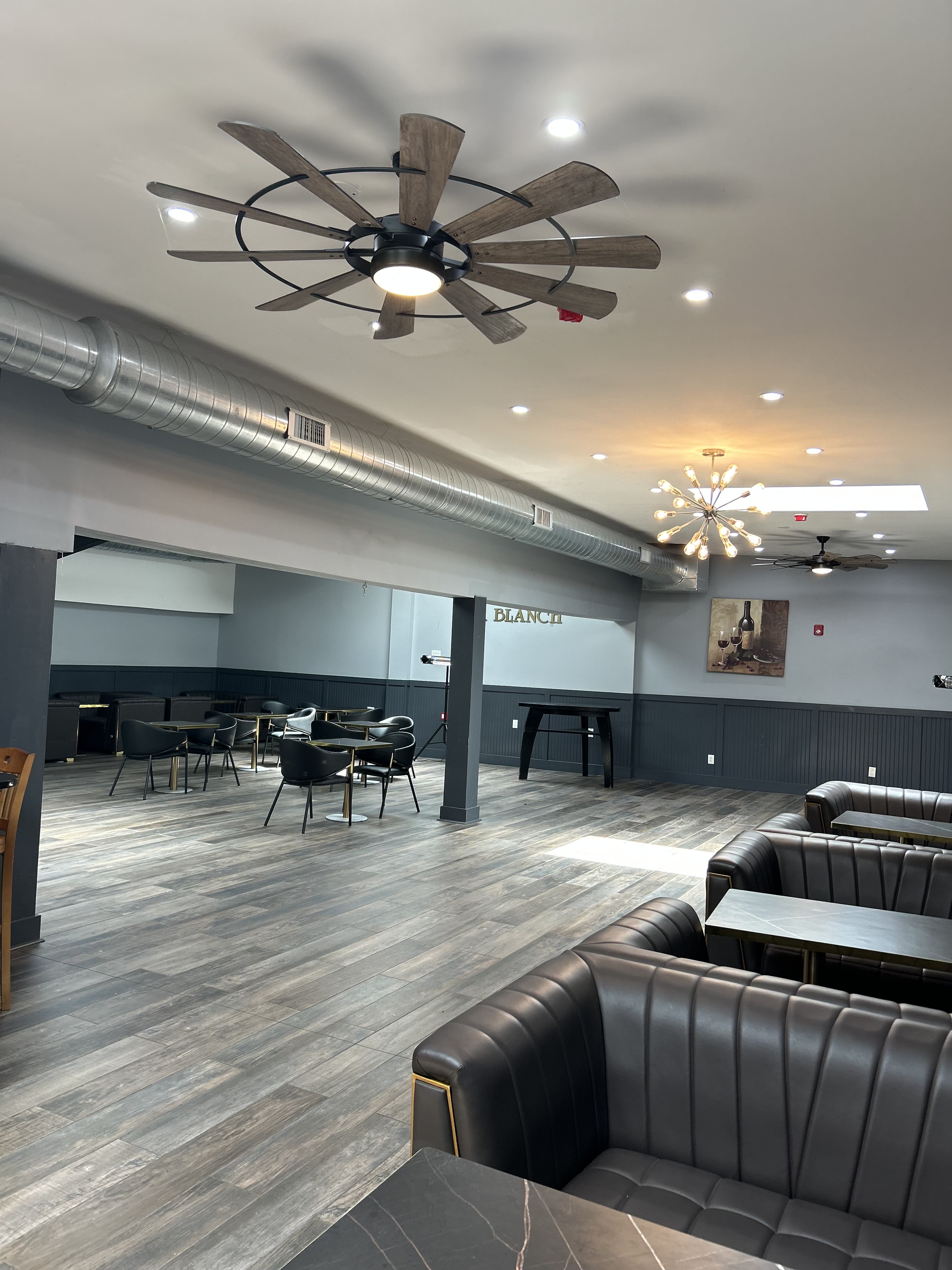 EnaBlanche Ballroom main hall — leather booths, Sputnik chandeliers, vaulted ceilings
